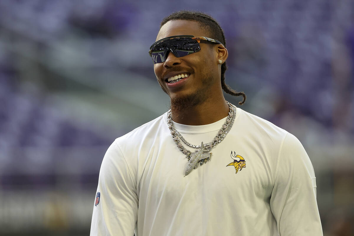 Minnesota Vikings wide receiver Justin Jefferson (18) looks on before an NFL football game agai ...