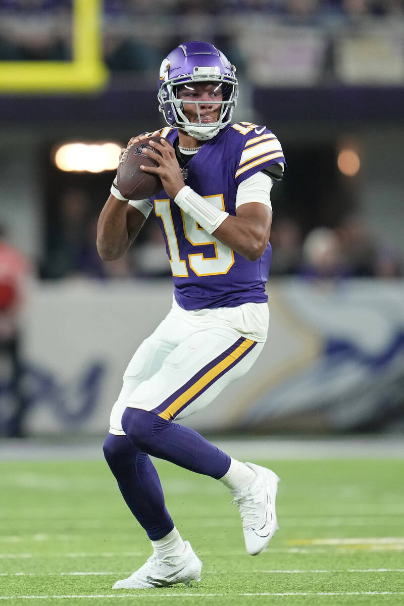 Minnesota Vikings quarterback Joshua Dobbs (15) looks to pass during the first half of an NFL f ...