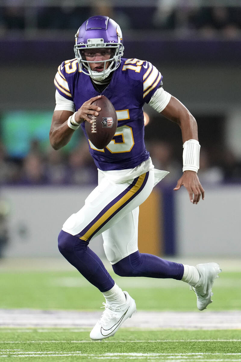 Minnesota Vikings quarterback Joshua Dobbs (15) runs with the football during the first half of ...