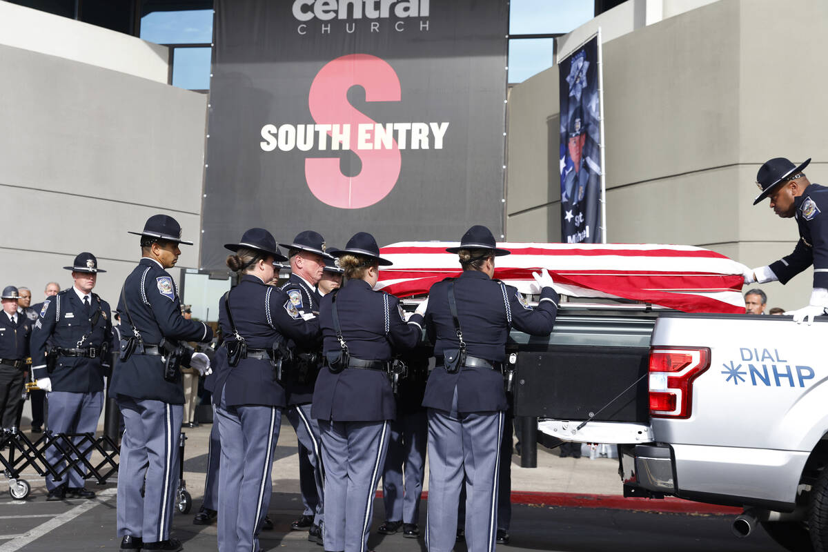 Members of the Honor Guard unload the casket carrying Nevada Highway Patrol Sgt. Michael Abbate ...