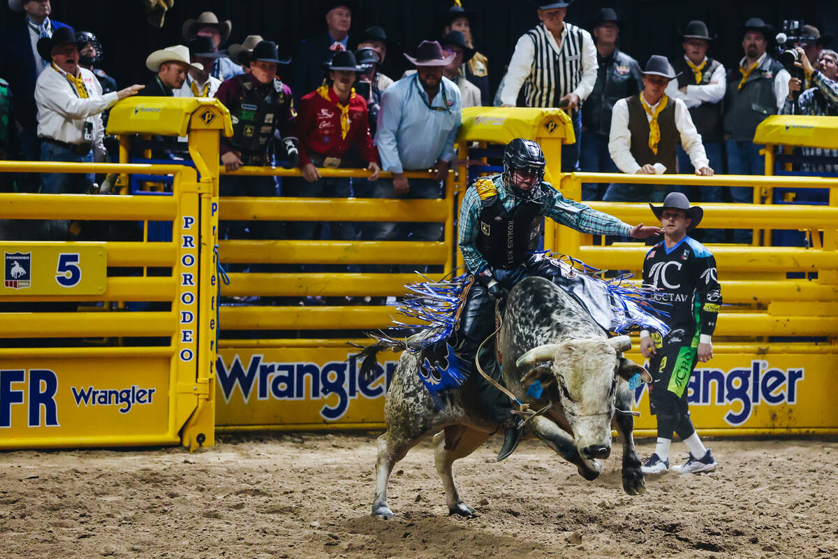 Jeff Askey rides a bull during day three of the National Finals Rodeo at the Thomas & Mack Cent ...