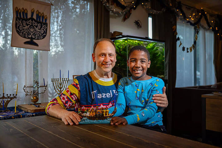 Adam Kulbersh, founder of Project Menorah, and his 6-year-old son Jack pose for a portrait on D ...