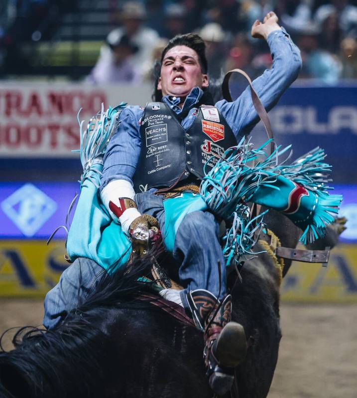 Jess Pope rides True Grit during round one of bareback riding at NFR in the Thomas & Mack C ...