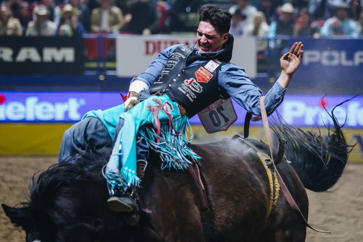 Jess Pope rides True Grit during round one of bareback riding at NFR in the Thomas & Mack C ...