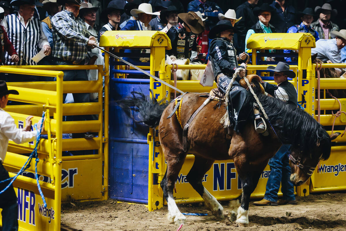 Sage Newman rides out of the bucking chute on Cat Walk during the National Finals Rodeo at the ...