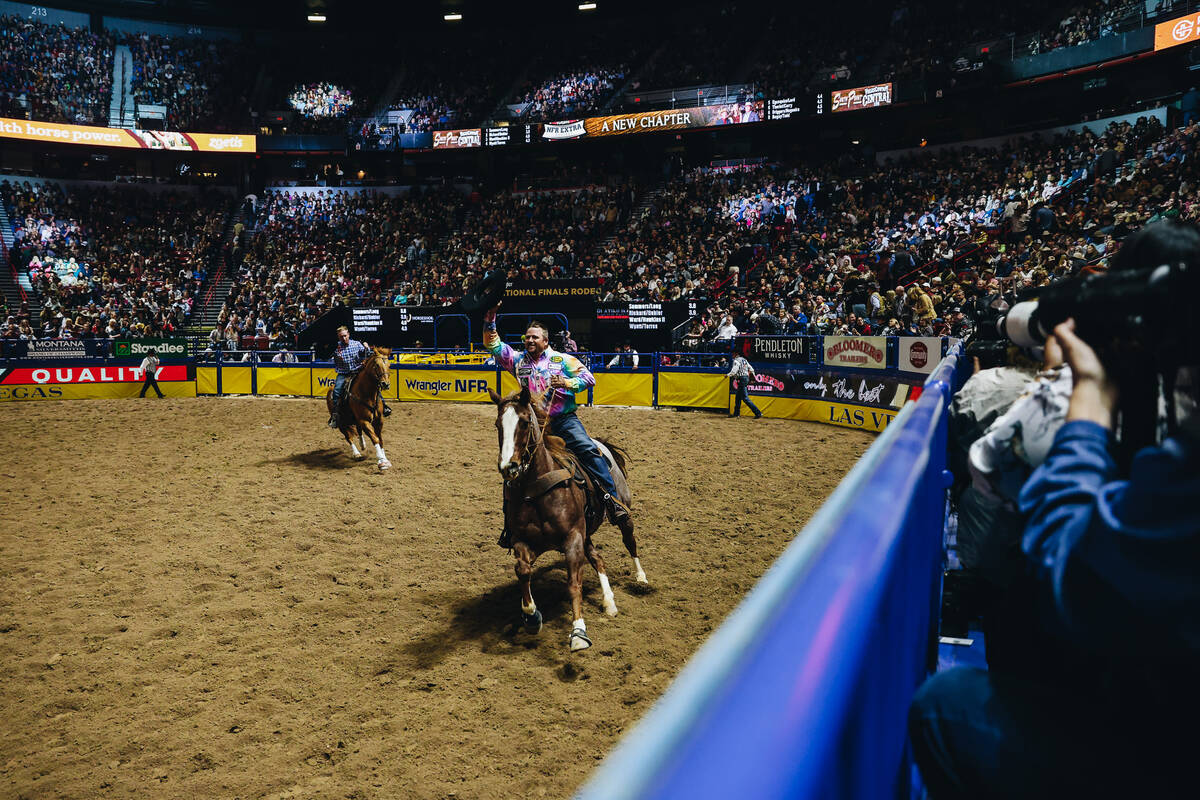 Jake Long tips his hat to the crowd during a victory lap at the National Finals Rodeo at the Th ...