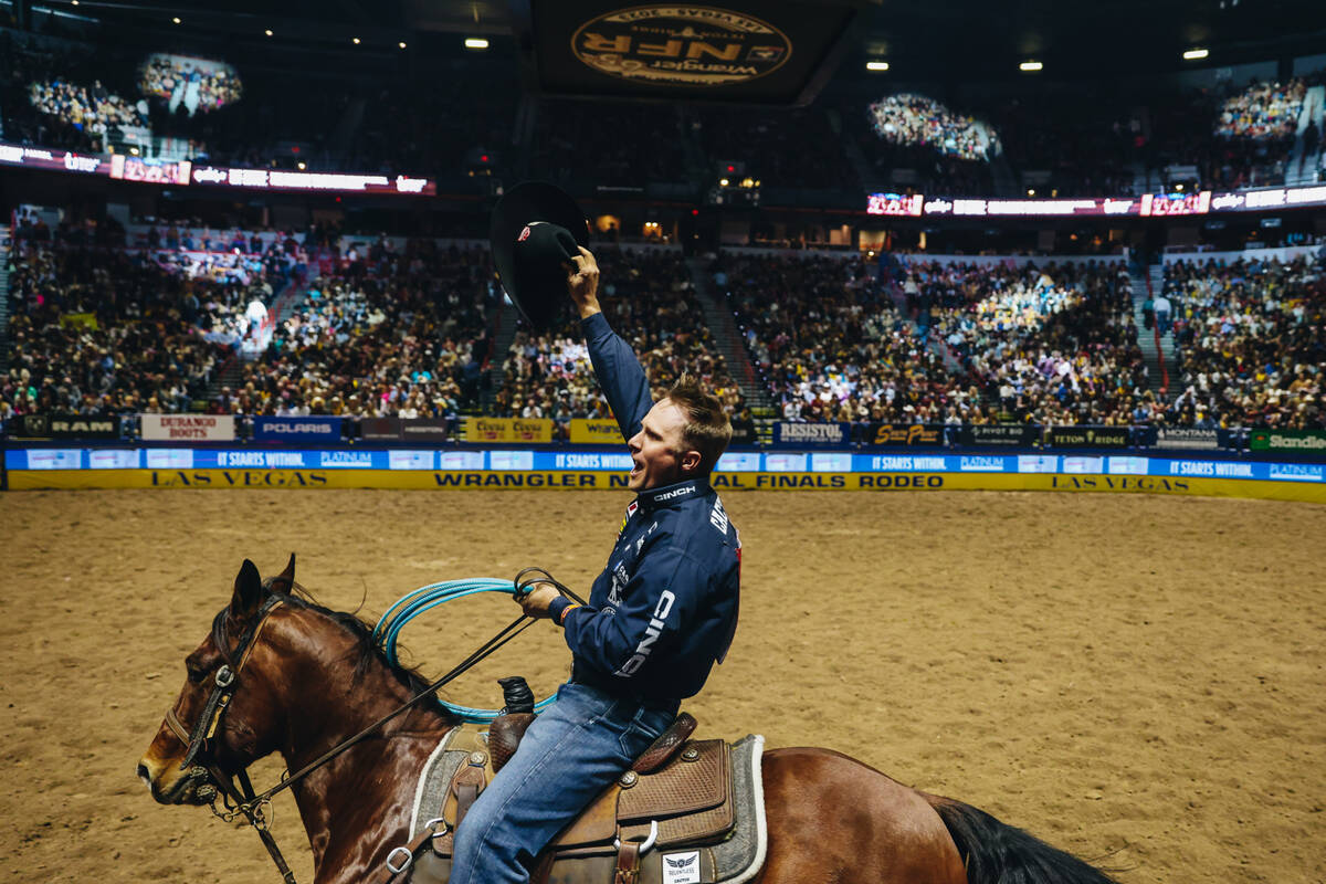 Logan Medlin celebrates during a victory lap after winning the team roping portion of day three ...