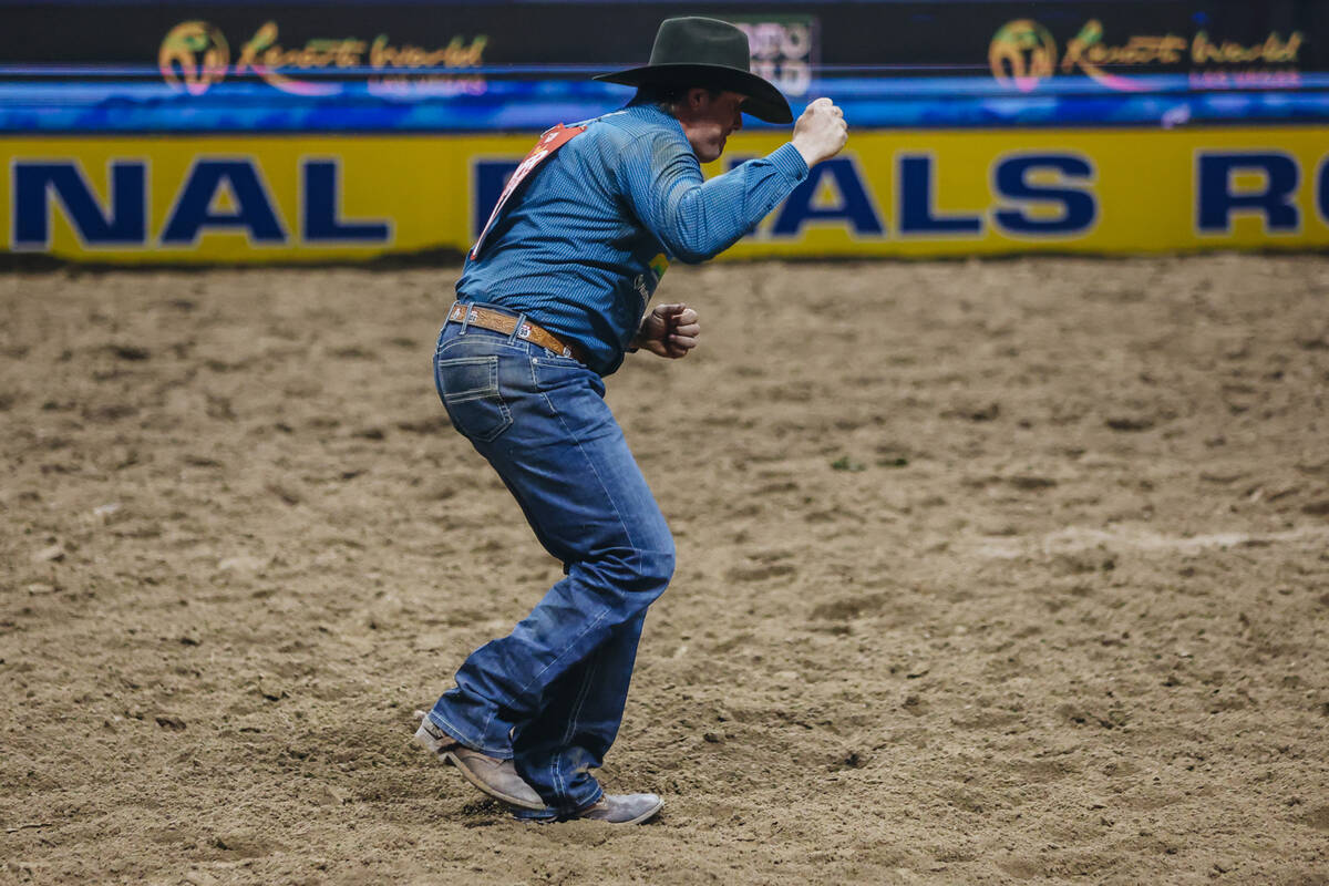 Nick Guy celebrates his time result during steer wrestling on day three of the National Finals ...