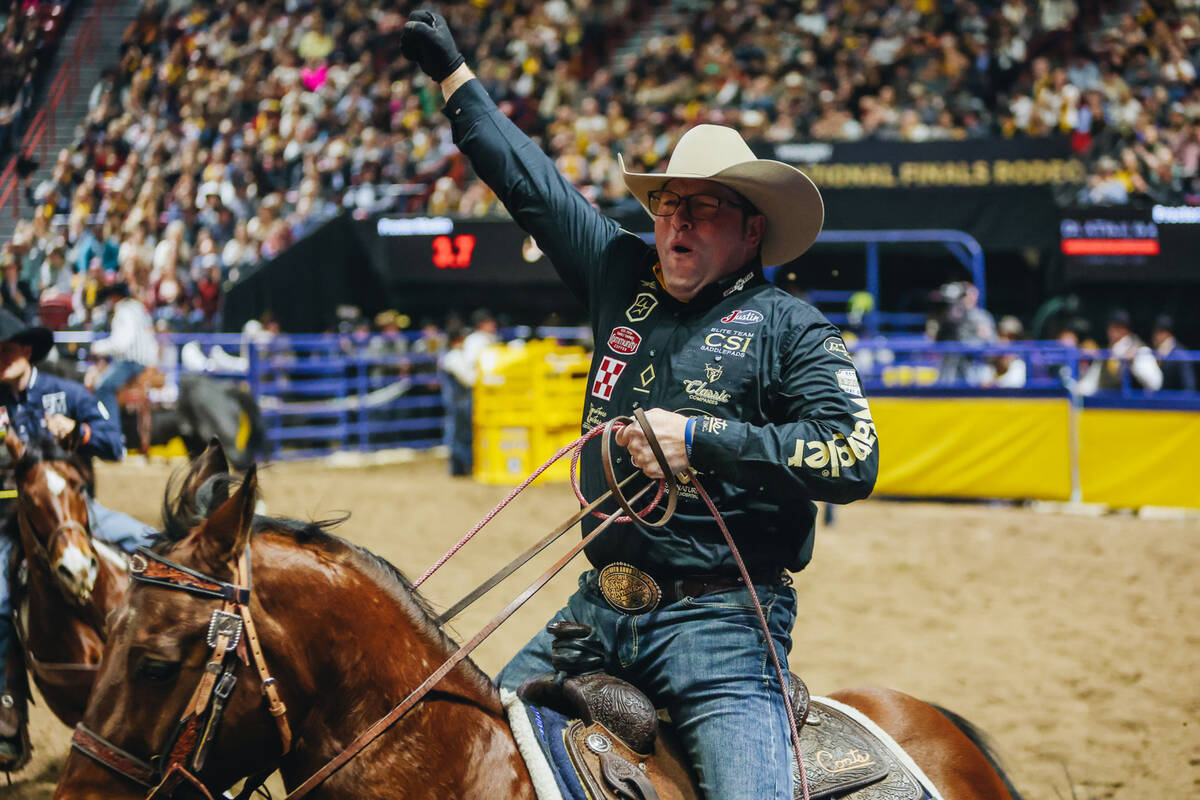 Coleman Proctor celebrates his time during day three of team roping at the National Finals Rode ...
