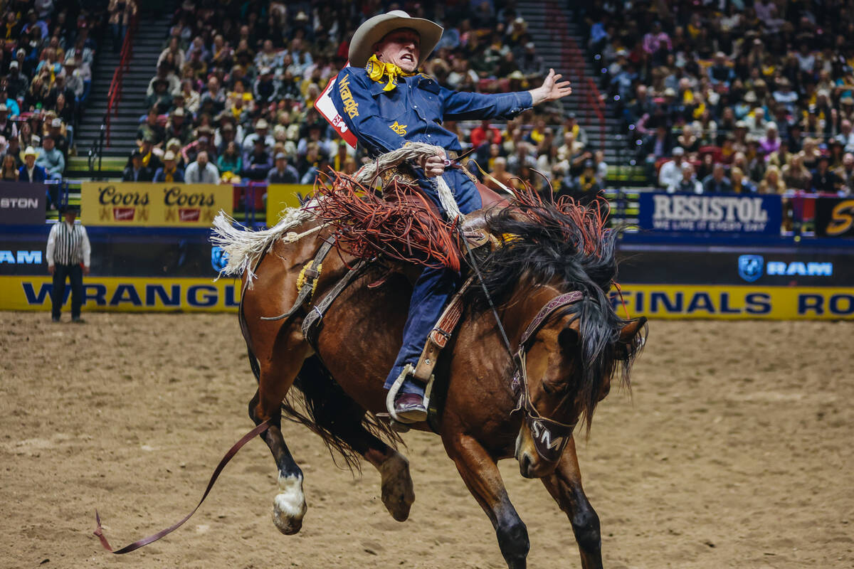 Ben Andersen gets bucked during day three of the National Finals Rodeo at the Thomas & Mack ...