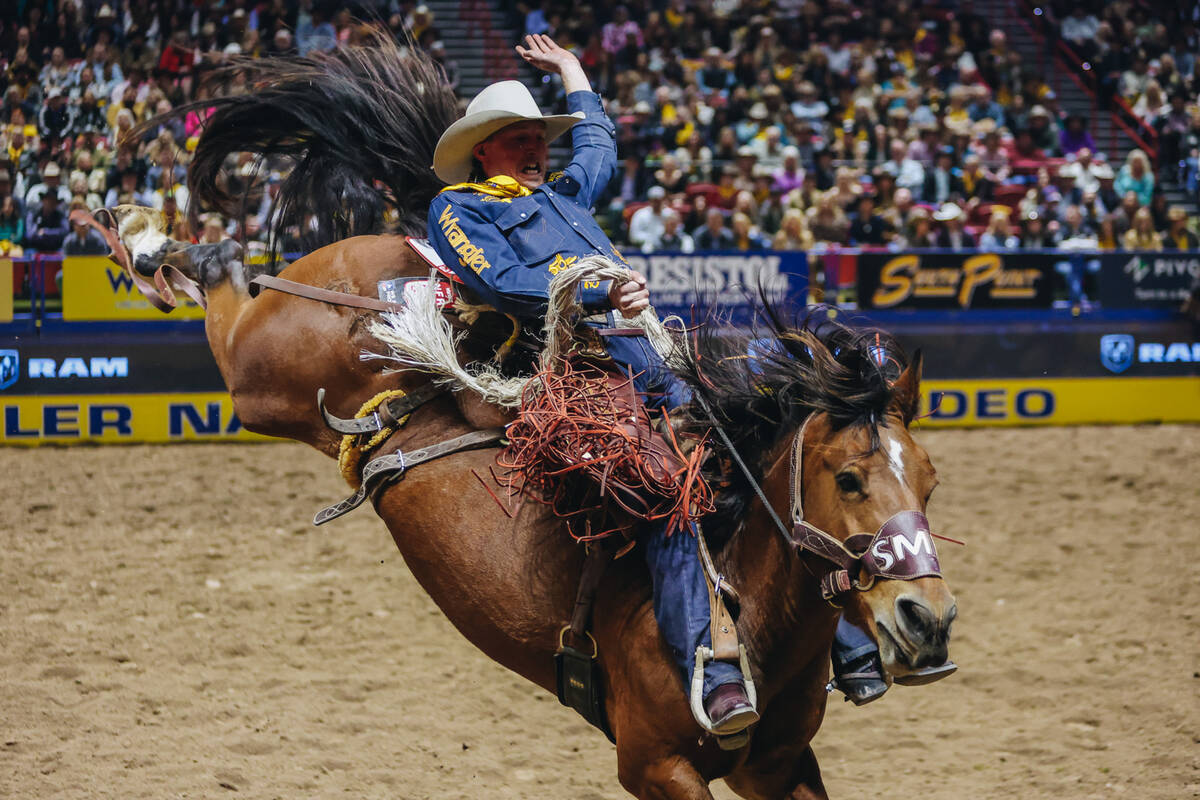 Ben Andersen gets bucked during day three of the National Finals Rodeo at the Thomas & Mack ...