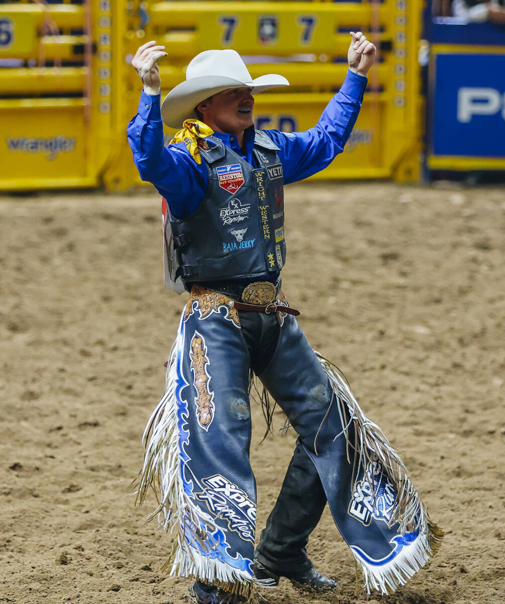 Ryder Wright celebrates his ride during saddle bronc riding on day three of the National Finals ...