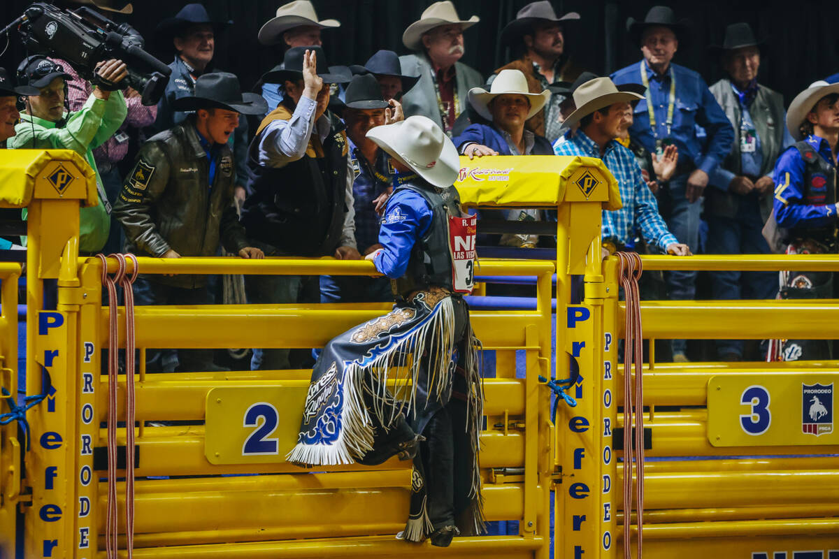 Ryder Wright celebrates his ride during saddle bronc riding on day three of the National Finals ...