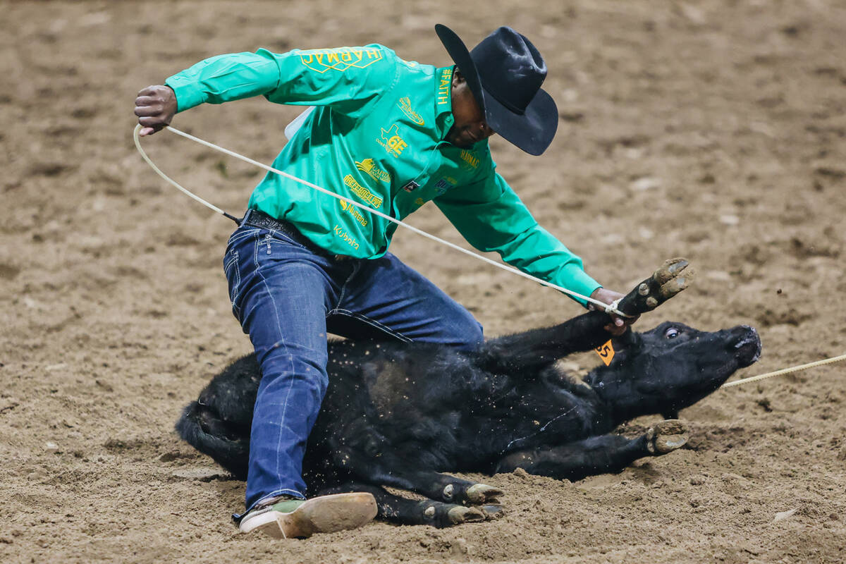 Cory Solomon ties down the calf during day three of the National Finals Rodeo at the Thomas &am ...