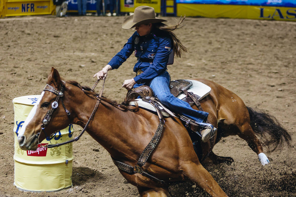 Brittany Pozzi Tonozzi rounds the barrel during day three of the National Finals Rodeo at the T ...