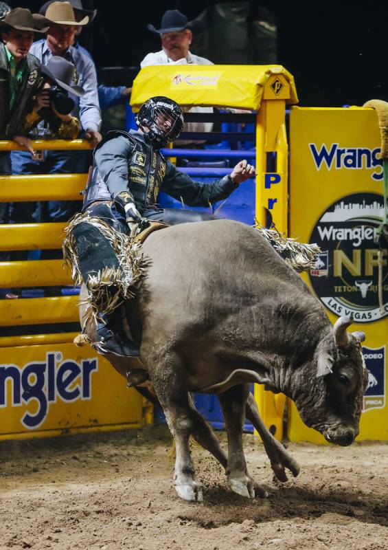 Sage Steele Kimzey rides a bull during day three of the National Finals Rodeo at the Thomas &am ...