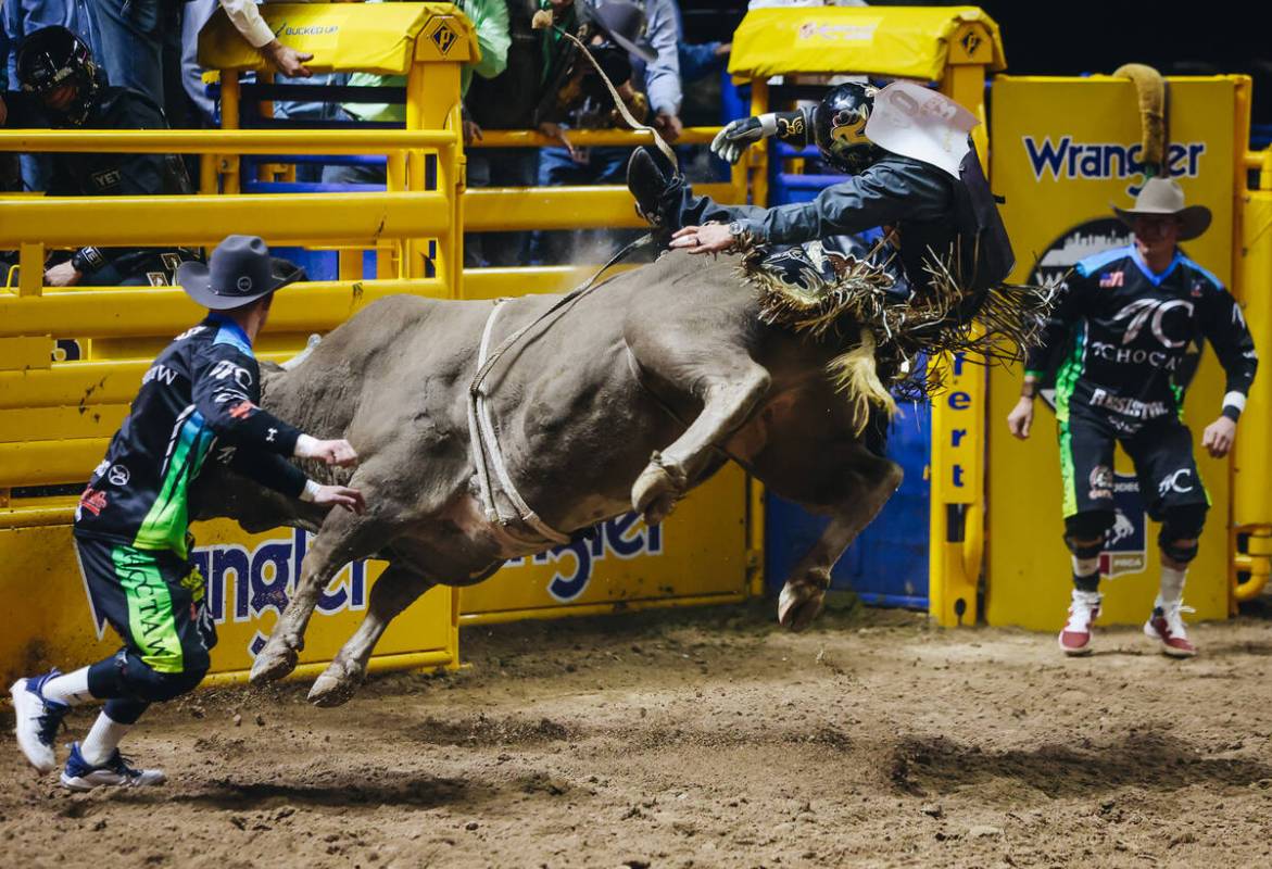 Sage Steele Kimzey rides a bull during day three of the National Finals Rodeo at the Thomas &am ...