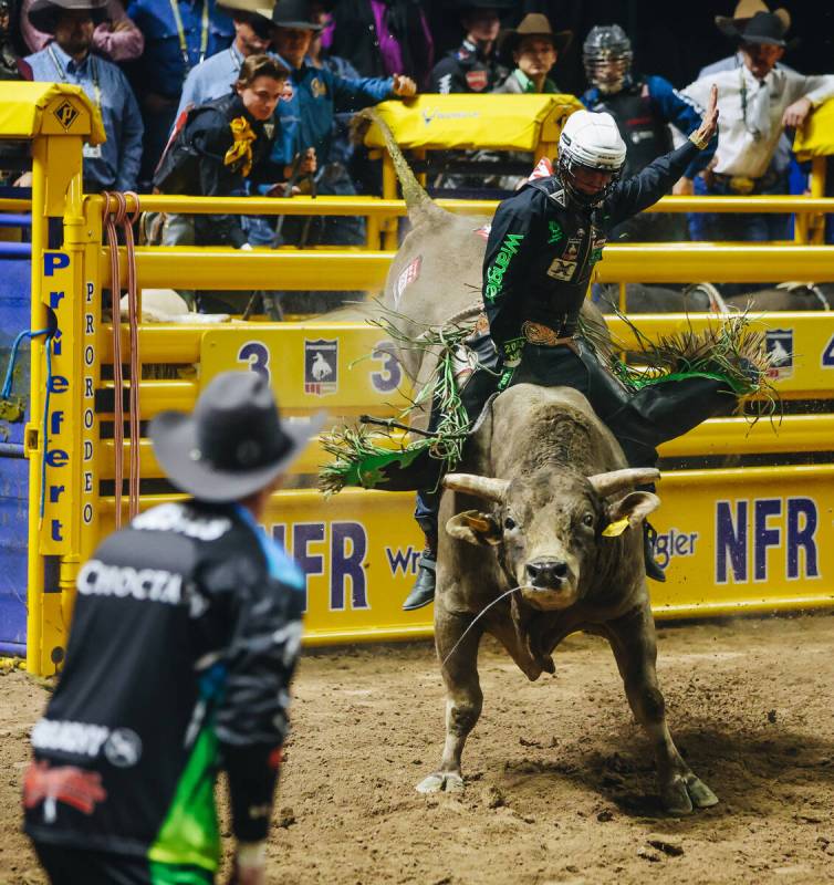 T Parker rides the bull during day three of the National Finals Rodeo at the Thomas & Mack ...