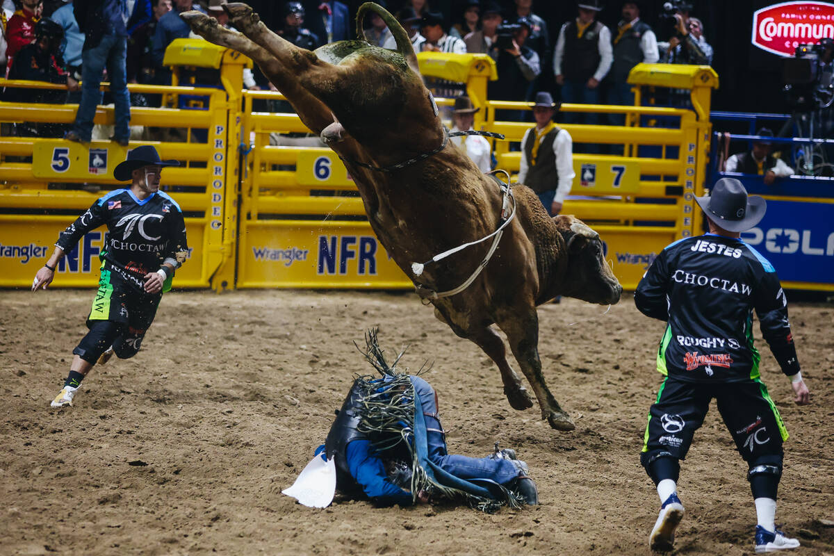 Creek Young falls into the dirt after his bull ride during day three of the National Finals Rod ...