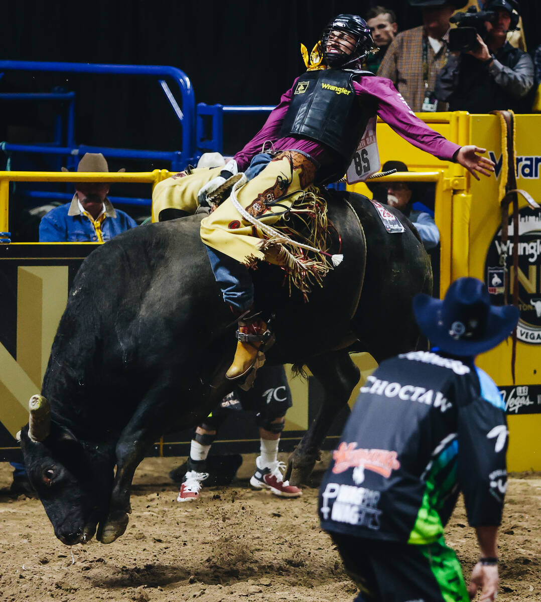 Jared Parsonage rides the bull during day three of the National Finals Rodeo at the Thomas &amp ...