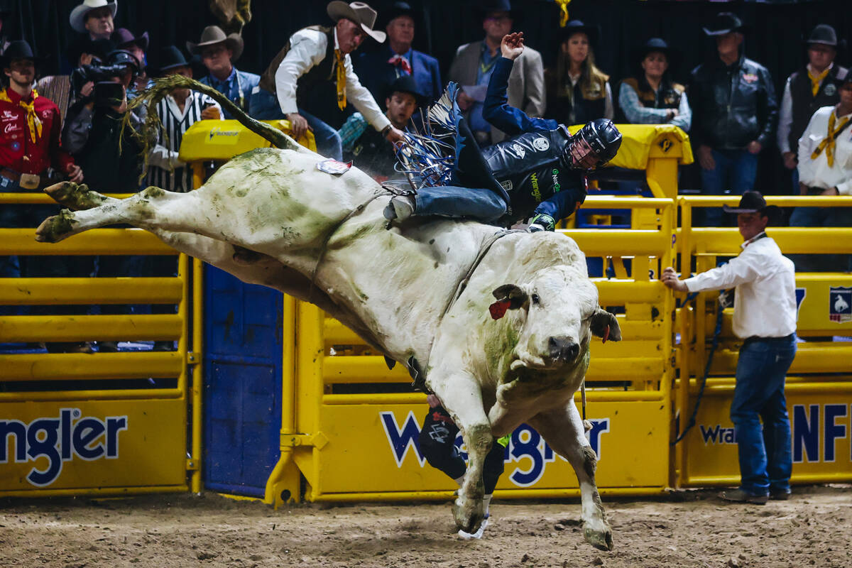 Josh Frost falls off the bull during day three of the National Finals Rodeo at the Thomas & ...