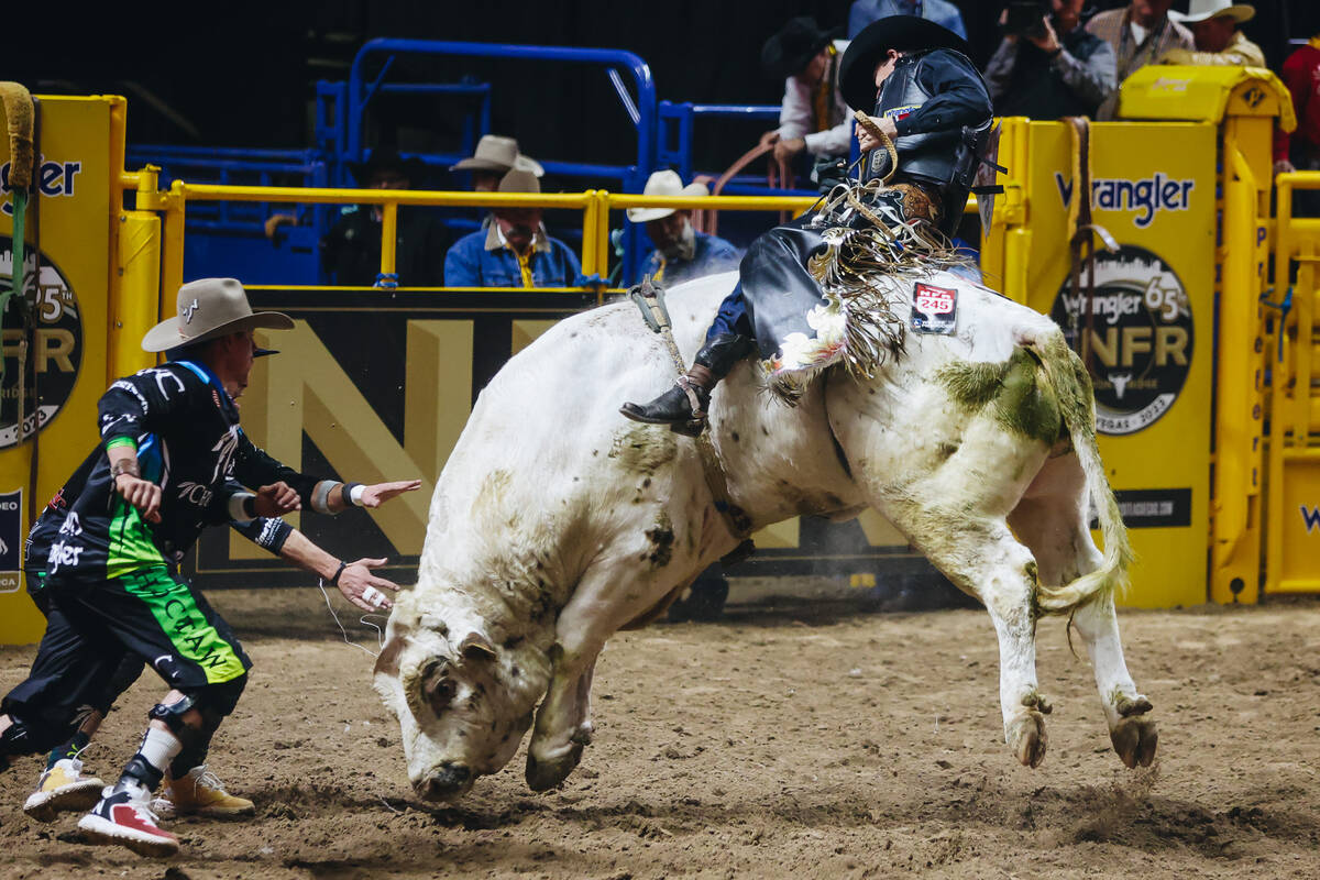 Ky Hamilton rides the bull during day three of the National Finals Rodeo at the Thomas & Ma ...