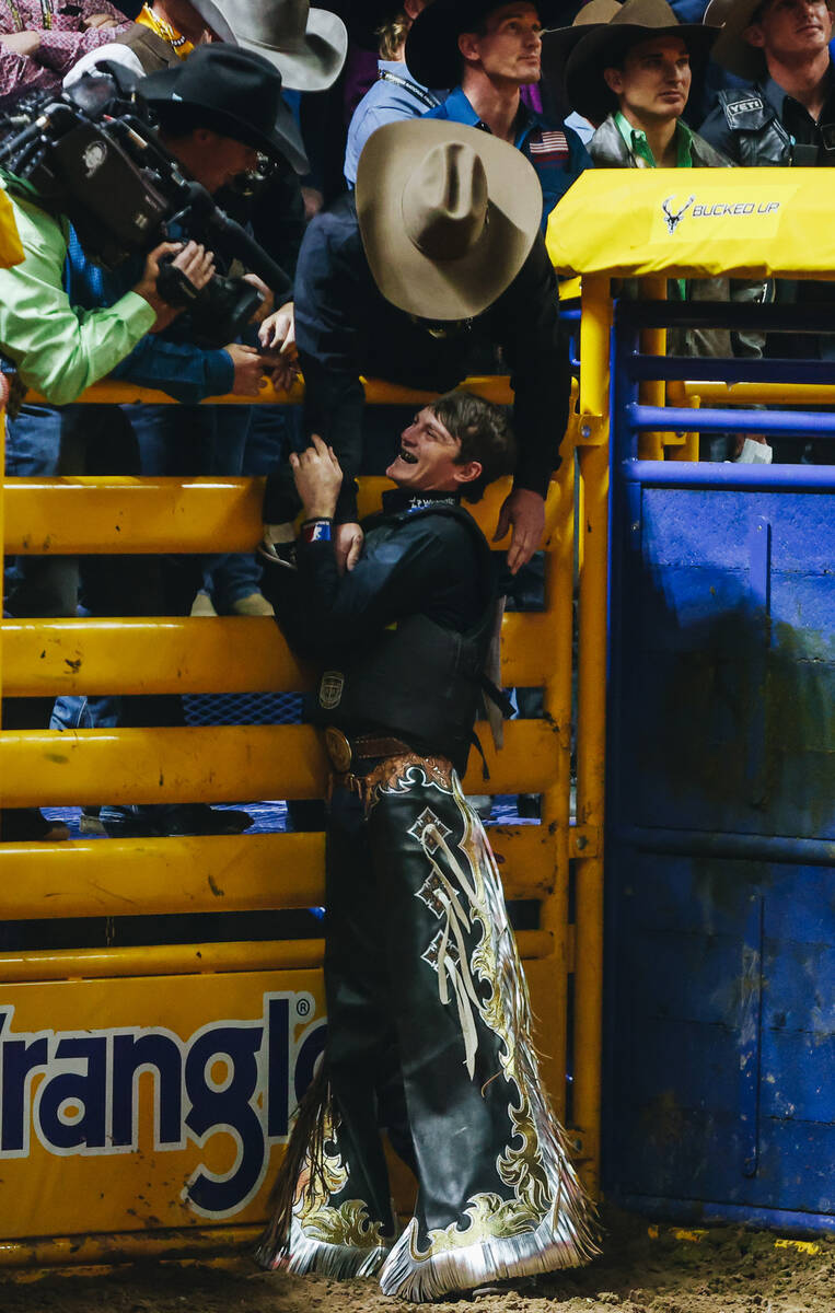 Ky Hamilton celebrates his bull ride during day three of the National Finals Rodeo at the Thoma ...