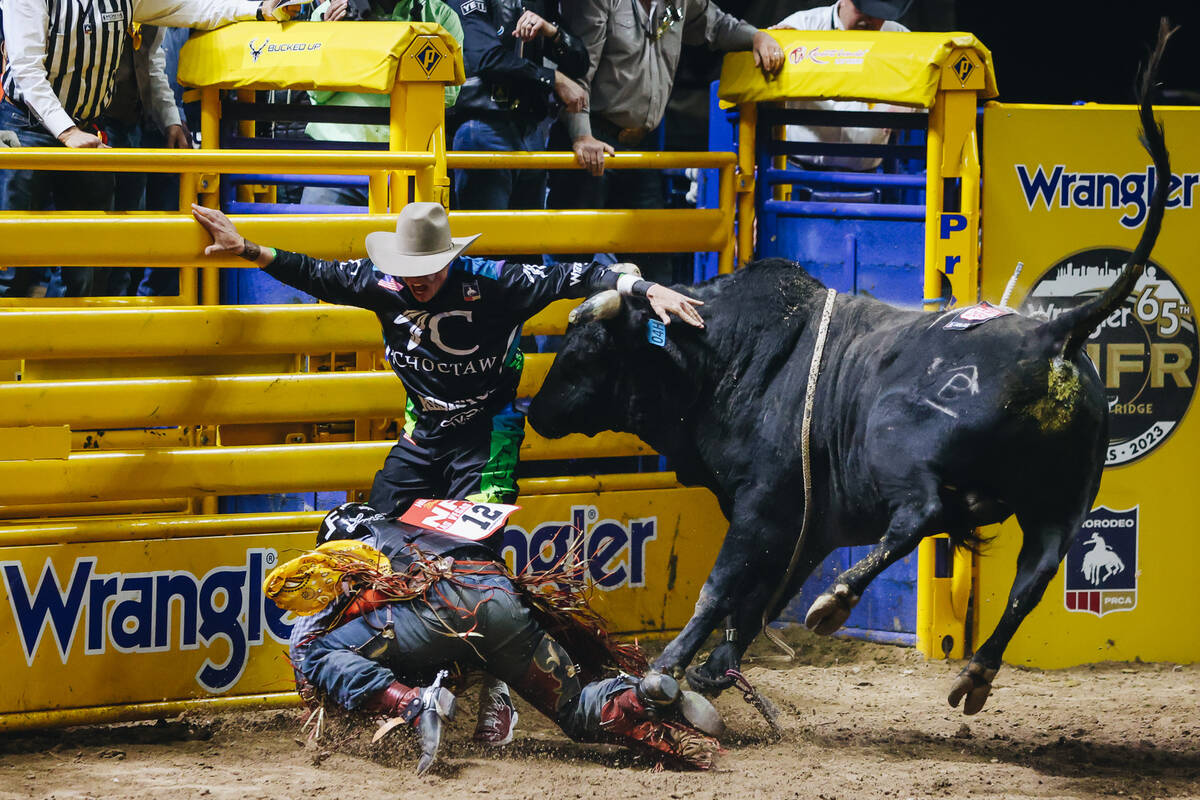 The bull charges at Trey Holston during day three of the National Finals Rodeo at the Thomas &a ...