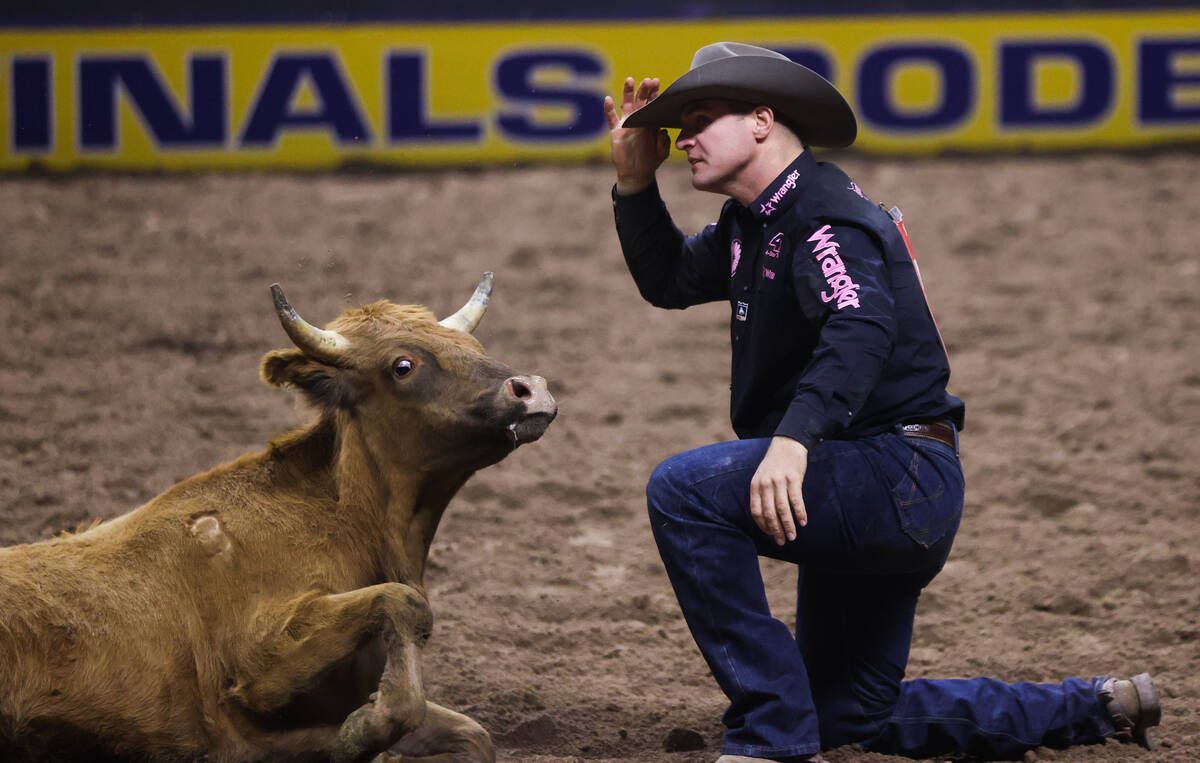 JD Struxness tips his hat after wrestling a steer to the ground while he competes in steer wres ...