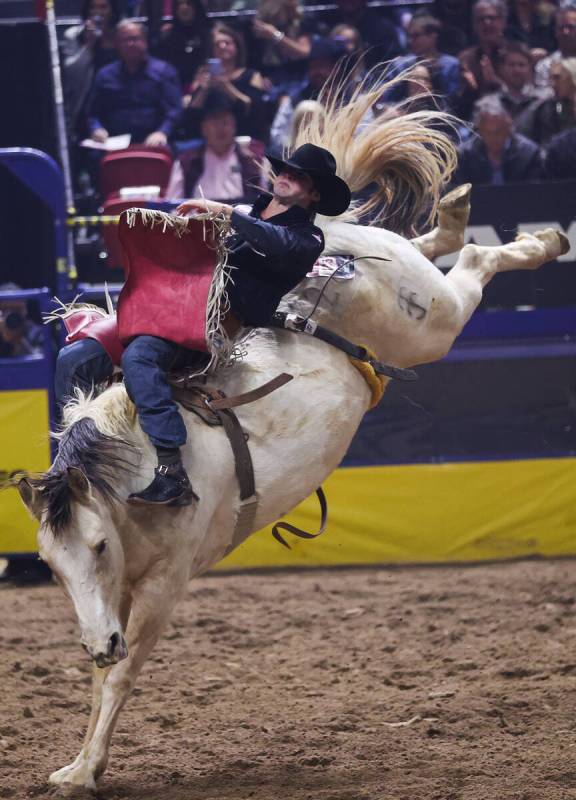 Leighton Berry holds on as he is bucked while he competes in bareback riding on day four of the ...