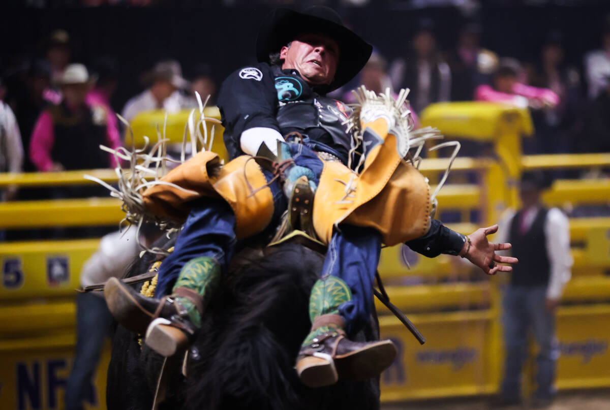 Richmond Champion leans back on his riggin while he competes in bareback riding on day four of ...