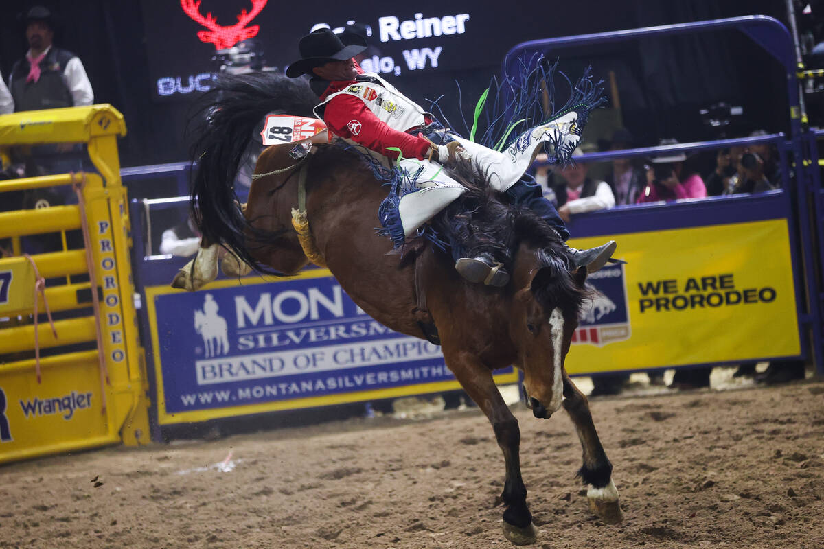 Cole Reiner reaches to beat his horse to the ground while he competes in bareback riding on day ...
