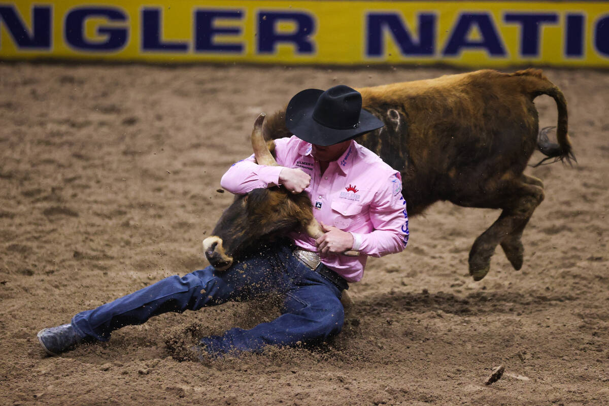 Ty Erickson gets his steer to the ground while he competes in steer wrestling on day four of th ...