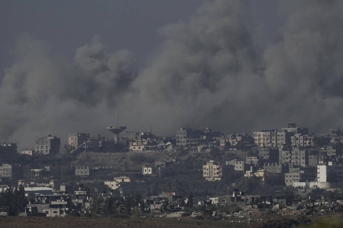 Smoke rises from the Gaza Strip after Israeli strikes on Saturday, Dec. 9, 2023. (AP Photo/Leo ...