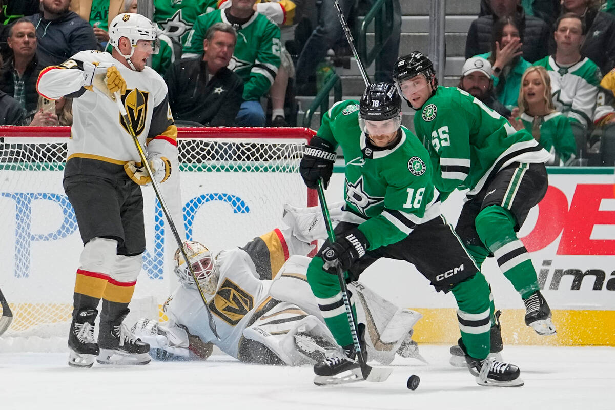 Vegas Golden Knights goaltender Logan Thompson, bottom, falls to the ice as Dallas Stars center ...