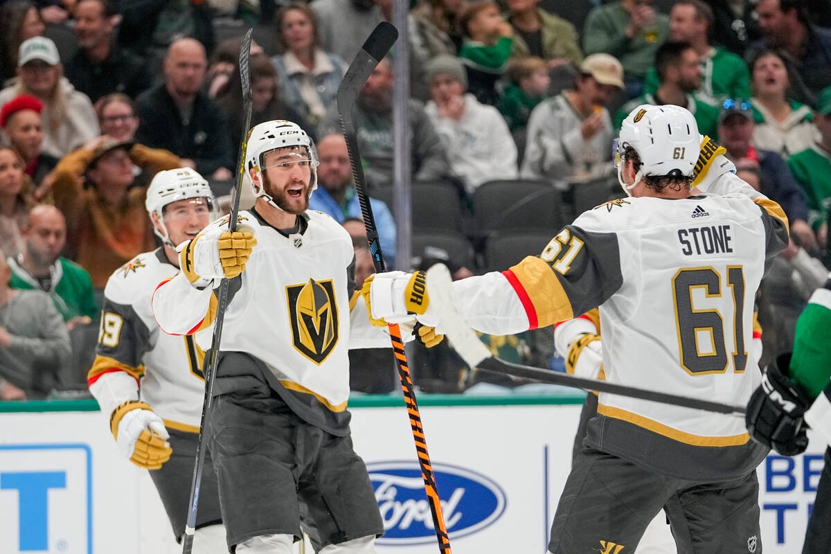 Vegas Golden Knights center Nicolas Roy, center, celebrates his goal with Mark Stone (61) and I ...