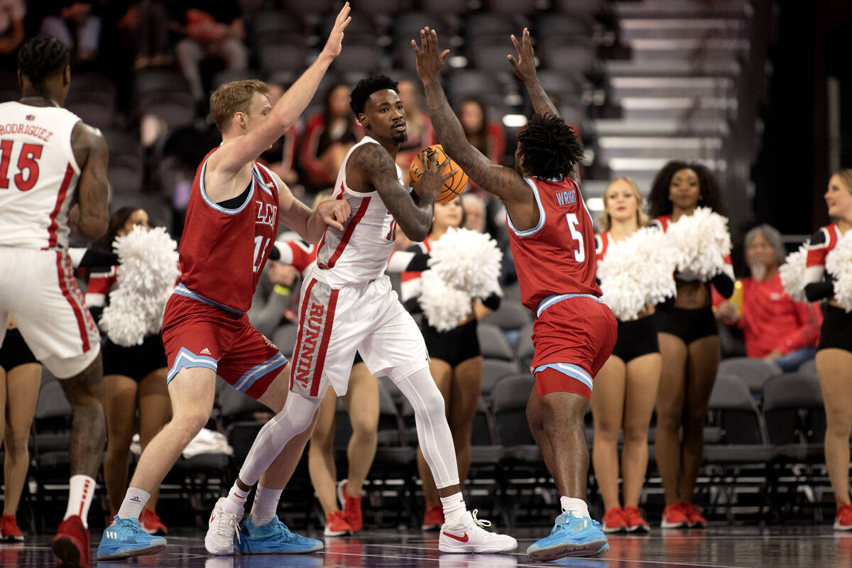 UNLV Rebels forward Kalib Boone (10) looks to pass while pressured by Loyola Marymount Lions ce ...