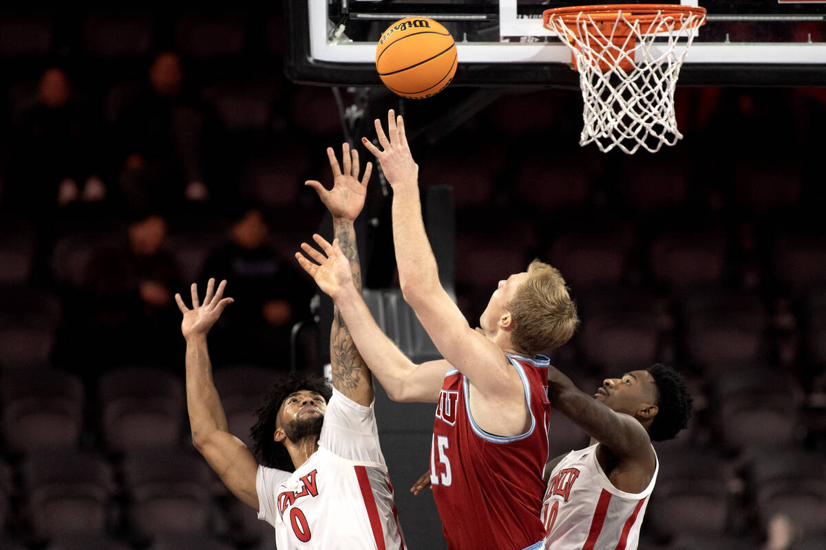 UNLV Rebels forward Isaiah Cottrell (0) and forward Kalib Boone (10) defend the hoop against Lo ...