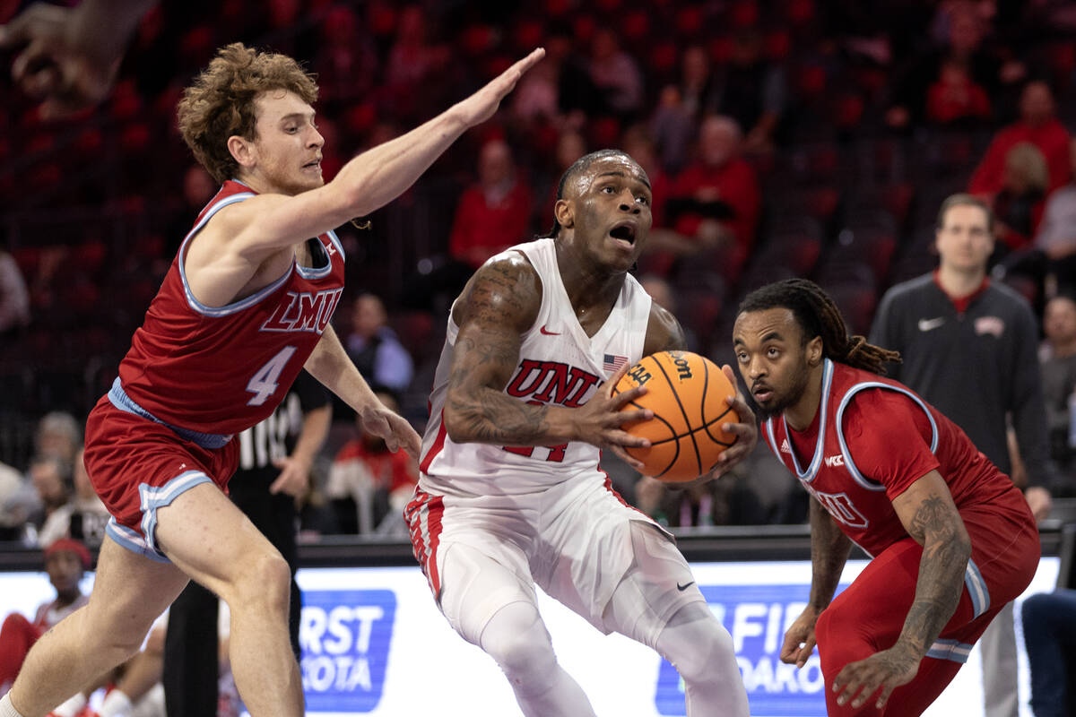 UNLV Rebels guard Jackie Johnson III (24) drives toward the hoop against Loyola Marymount Lions ...