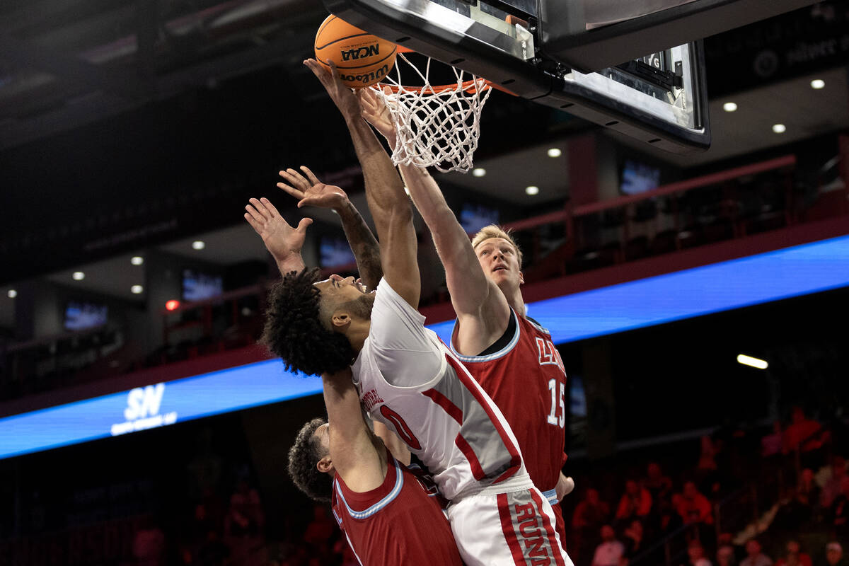 UNLV Rebels forward Isaiah Cottrell (0) shoots against Loyola Marymount Lions forward Alex Merk ...