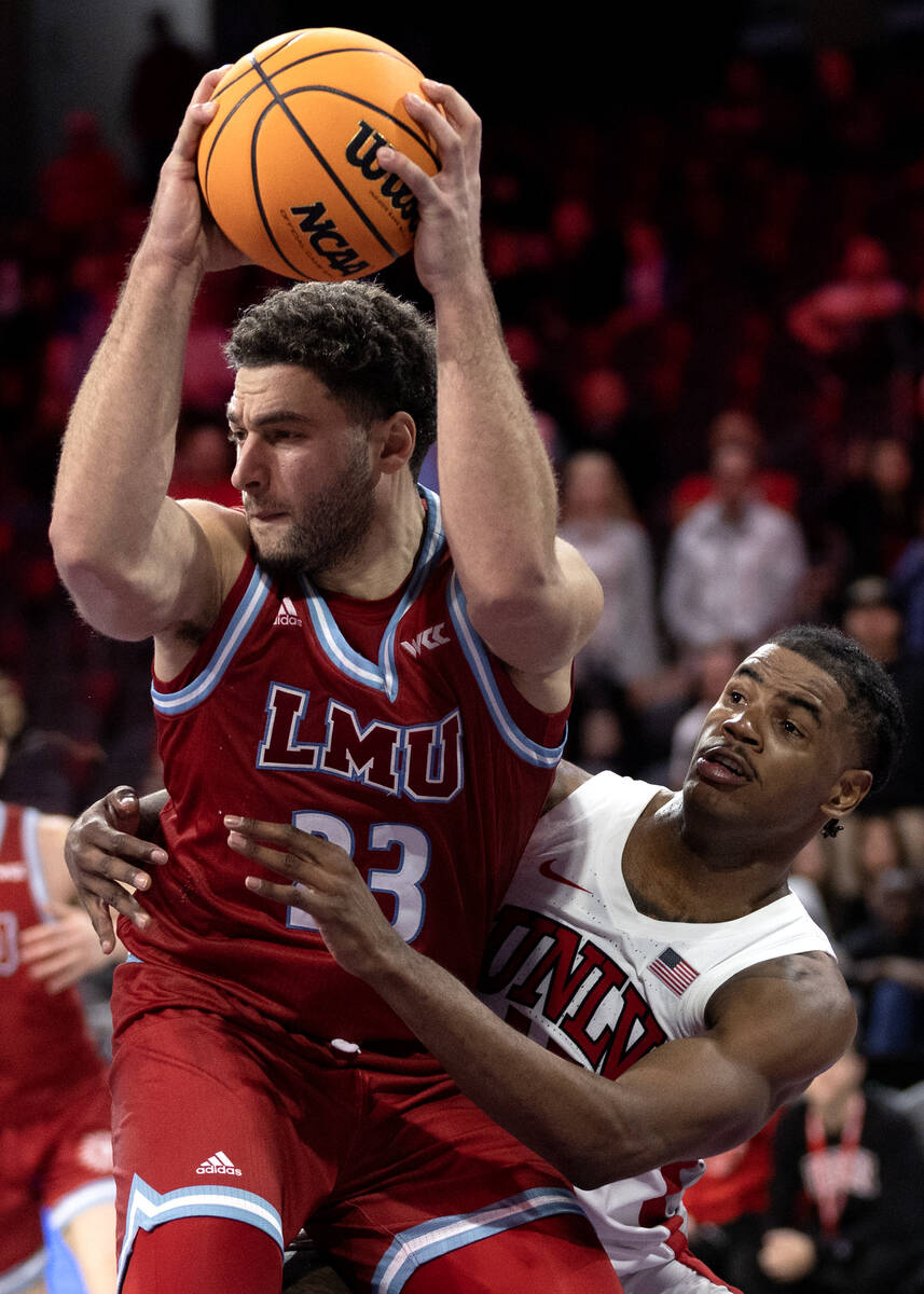 UNLV Rebels guard Luis Rodriguez (15) surrounds Loyola Marymount Lions forward Alex Merkviladze ...