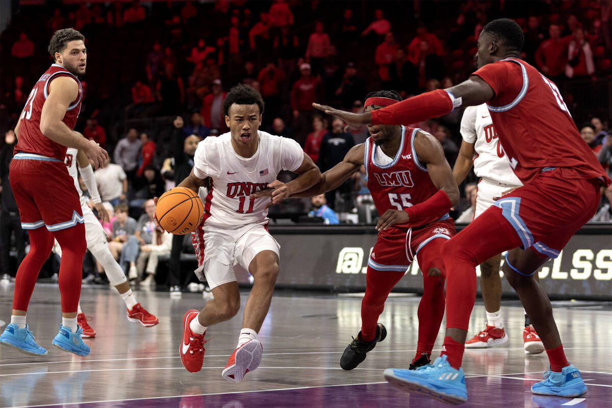 UNLV Rebels guard Dedan Thomas Jr. (11) drives toward the hoop against Loyola Marymount Lions g ...