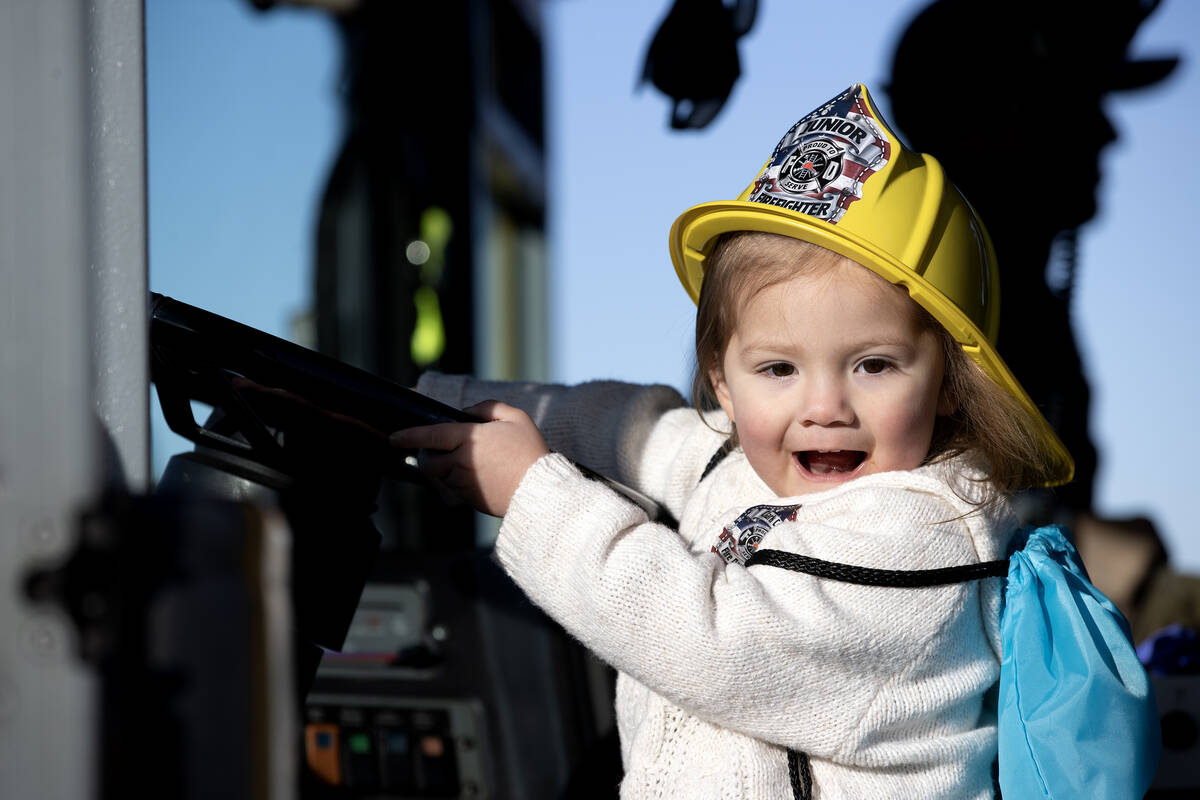 Holland Gonzalez, 2, drives a firetruck during a community event put on by the Clark County Fir ...