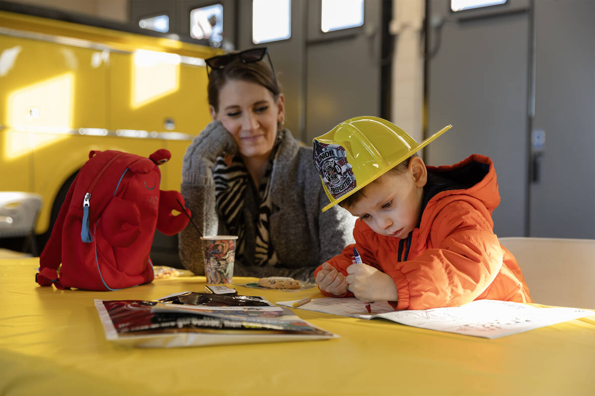 Luke Muecke, 4, colors while his mom Erika Muecke watches during a community event put on by th ...