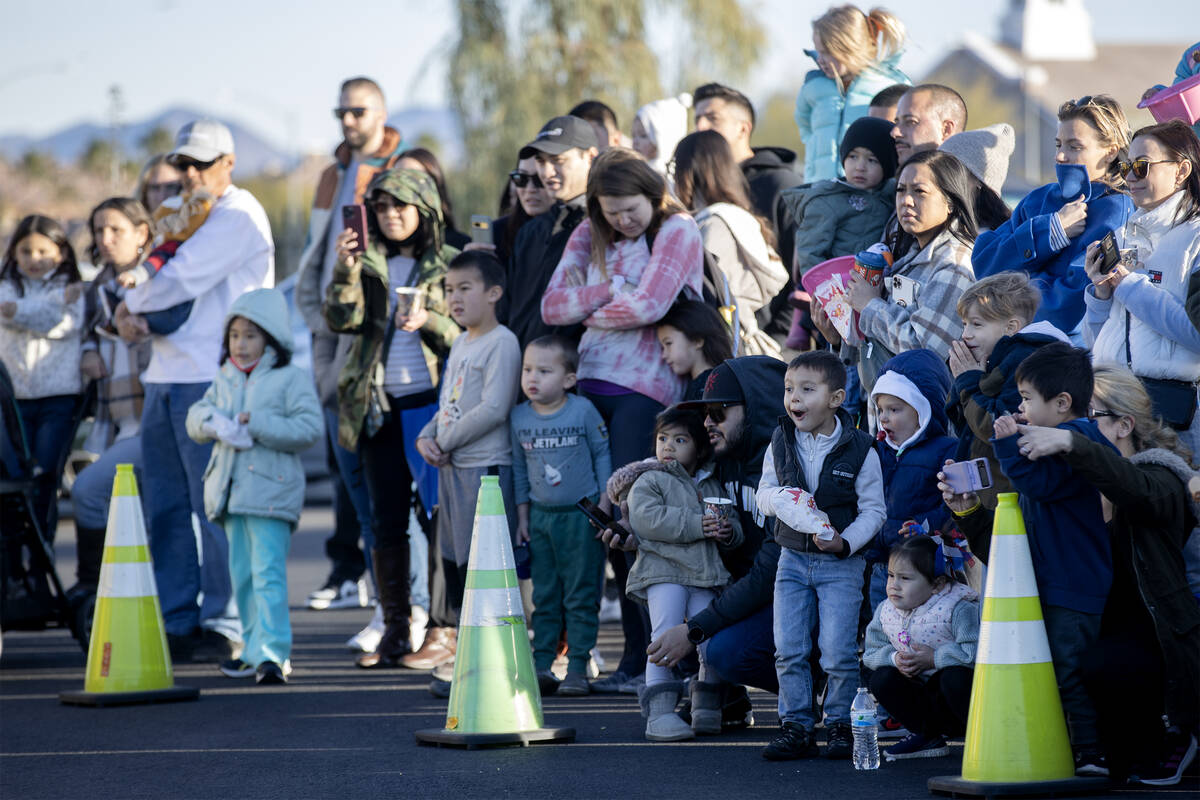 Attendees of a community event put on by the Clark County Fire Department watch firefighters pe ...