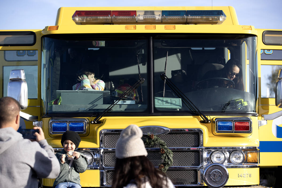 Familes tour a fire truck during a community event put on by the Clark County Fire Department a ...