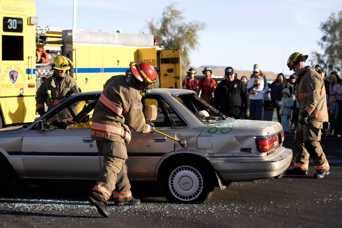 Firefighters demolish a car during a model extraction during a community event put on by the Cl ...