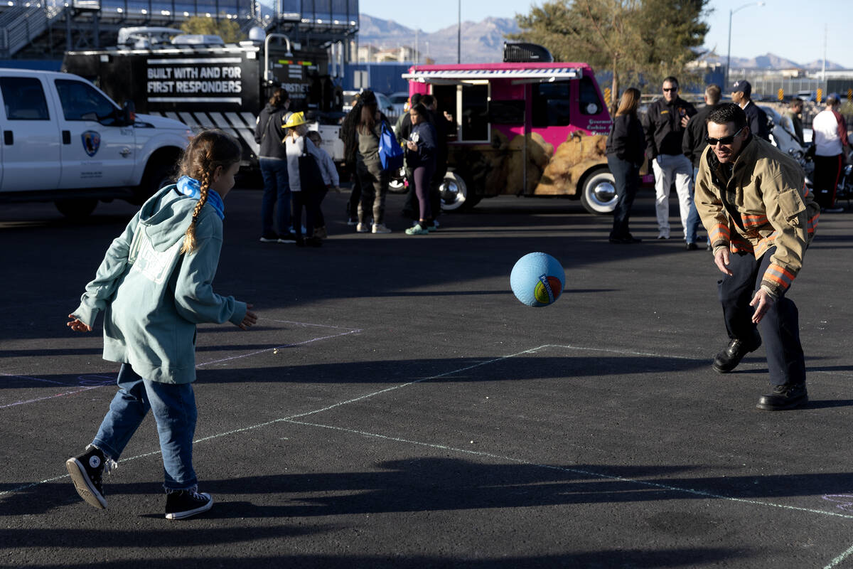 Clark County Fire Deputy Chief Thomas Touchstone plays with his daughter Hudsynn Touchstone, 8, ...