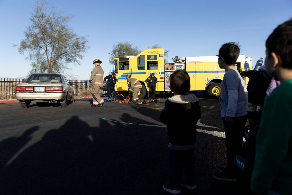 Firefighters perform a model extraction during a community event put on by the Clark County Fir ...