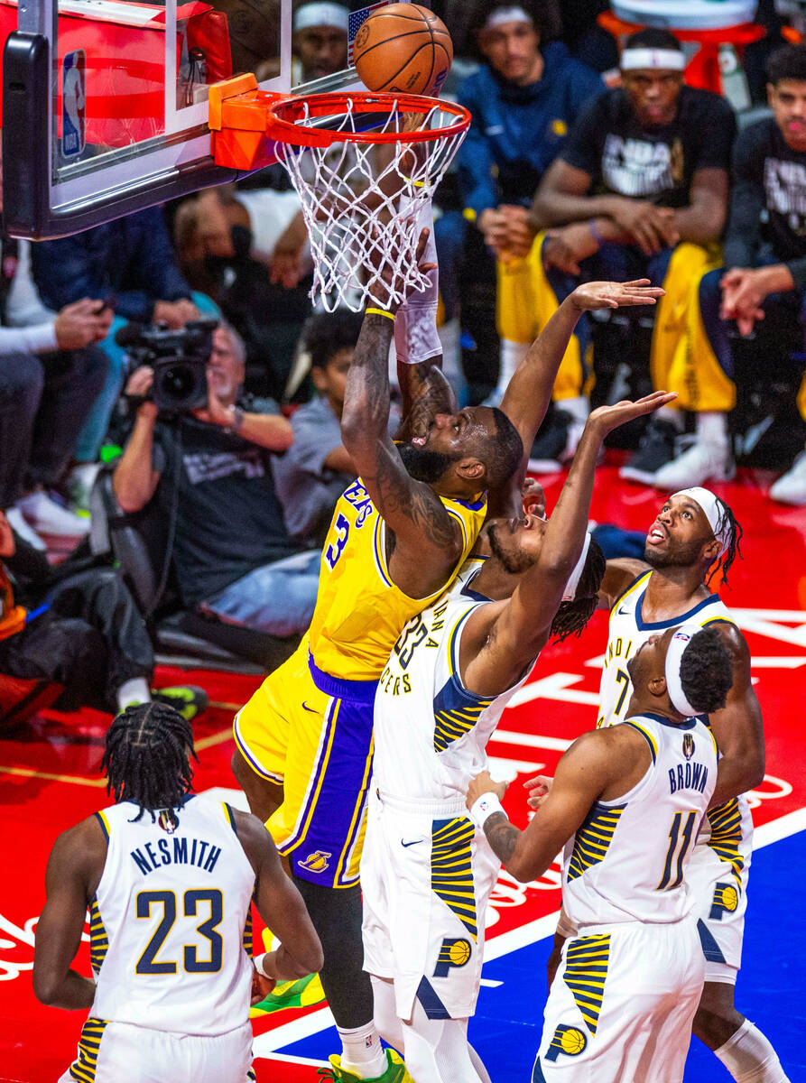 Los Angeles Lakers forward LeBron James (23) gets off shot against Indiana Pacers forward Aaron ...